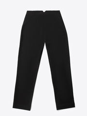 A close-up of a woman's hand placing into a front pocket of black high-waisted fitted pants.