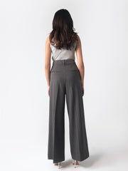 Low-rise black wide leg pants with a fitted belt, pleats, and multiple pockets, designed for a formal and smart look.