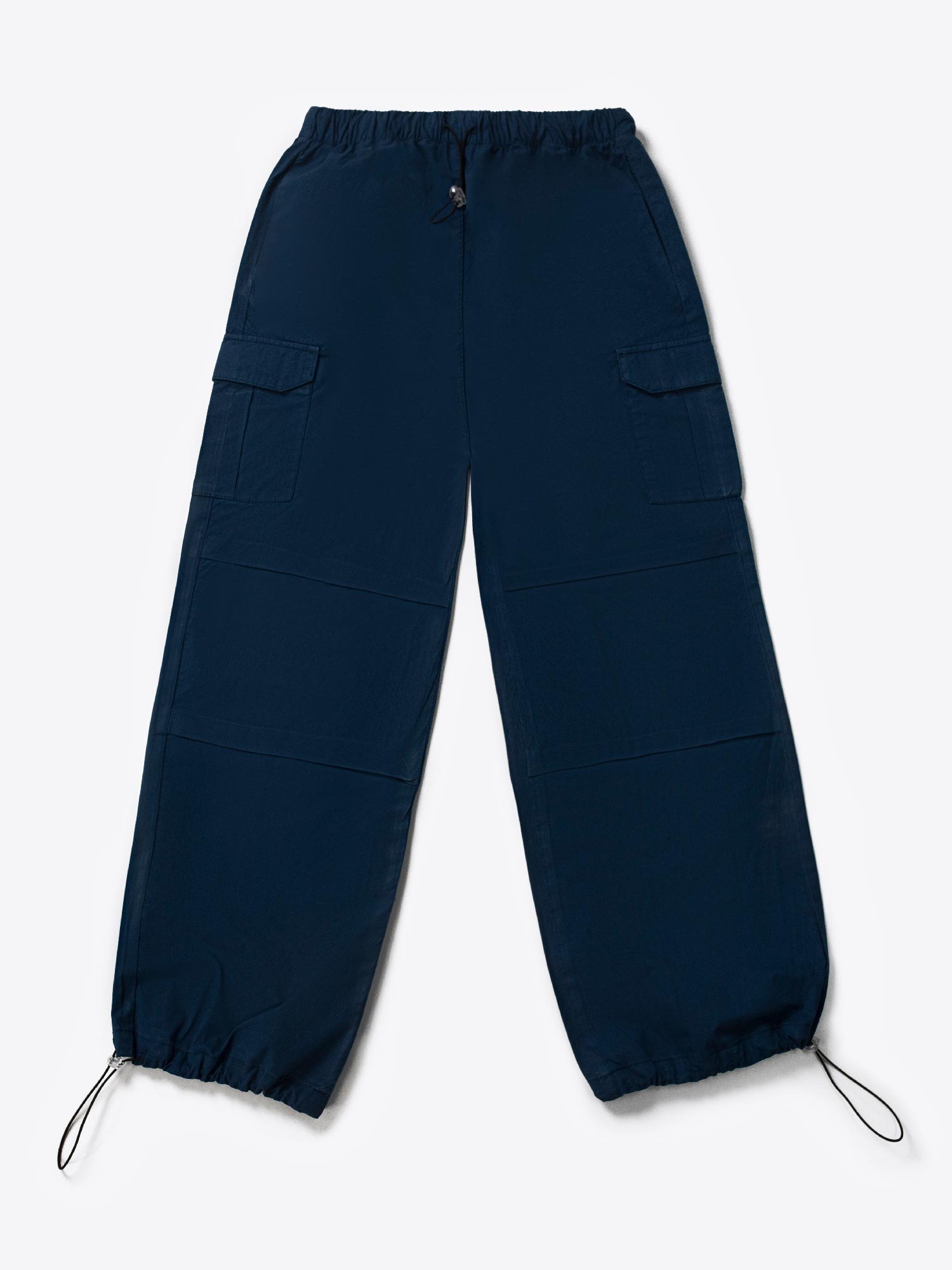 A woman standing and facing to the side, wearing navy blue wide leg cargo pants with an elasticated waistband and drawcord details.