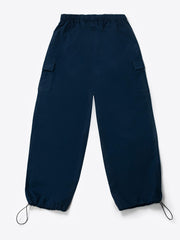A woman standing and facing to the side, wearing navy blue wide leg cargo pants with an elasticated waistband and drawcord details.