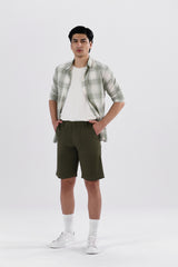A pair of olive green safari shorts for men with a non-functional belt strap, classic patch pockets, and a zip fly opening.