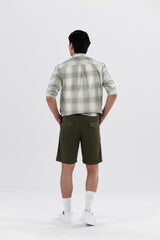 A pair of olive green safari shorts for men with a non-functional belt strap, classic patch pockets, and a zip fly opening.
