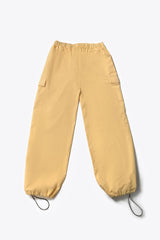 A person wearing yellow wide leg cargo pants with an elasticated waistband and side cargo pockets.