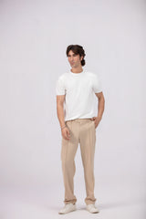 Man wearing a white t-shirt and beige pants on a white background