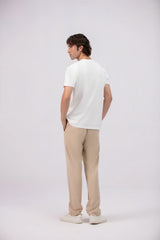 Man wearing a white t-shirt and beige pants on a white background